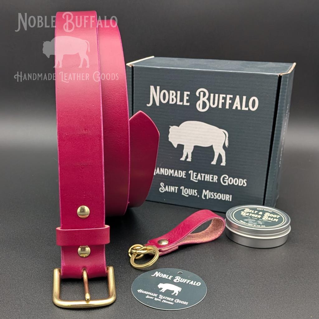 Handmade amaranth purple leather belt by Noble Buffalo. Bold reddish purple full grain leather belt with warm plum and wine purple tones. Colorful unisex leather belt accessory.