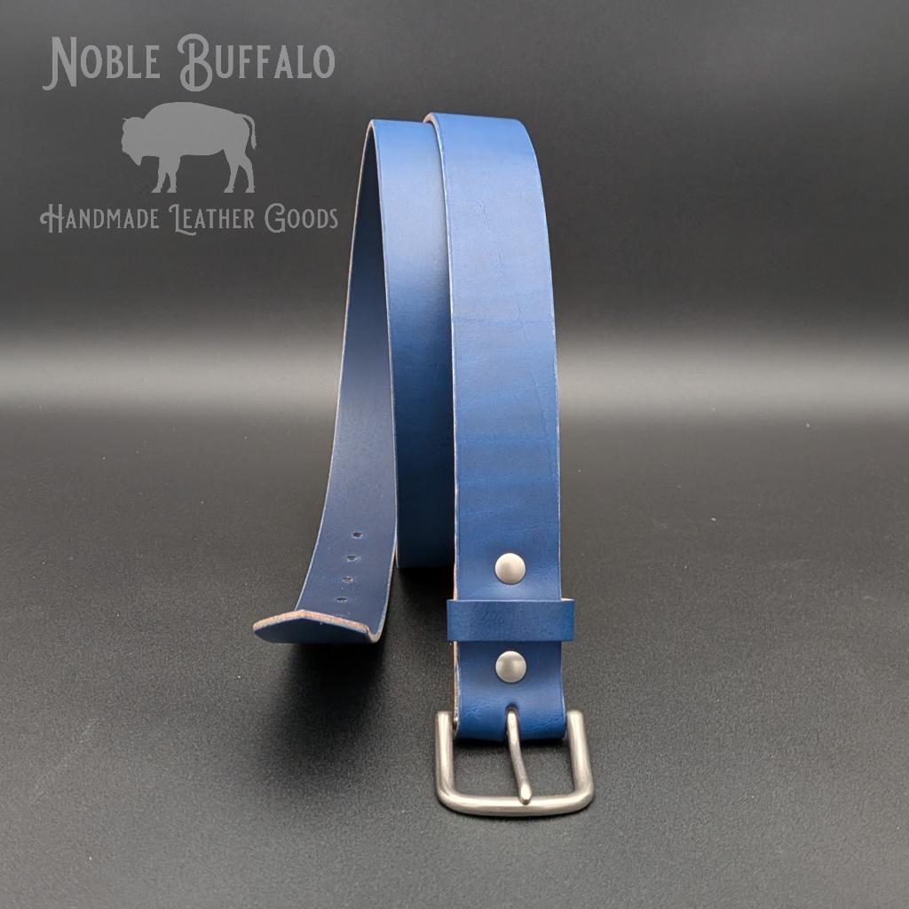 Handmade bluebonnet blue leather belt by Noble Buffalo. Vibrant bright blue full grain leather belt with rich royal and cobalt tones. Colorful unisex leather belt accessory and keychain, handmade in Saint Louis, MO by Noble Buffalo.