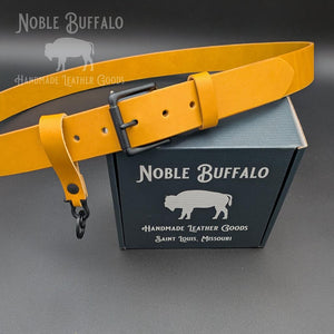 Handmade goldenrod yellow leather belt by Noble Buffalo. Vibrant yellow full grain leather belt with warm sunflower and mustard tones. Unisex handmade accessory and colorful outfit statement piece.