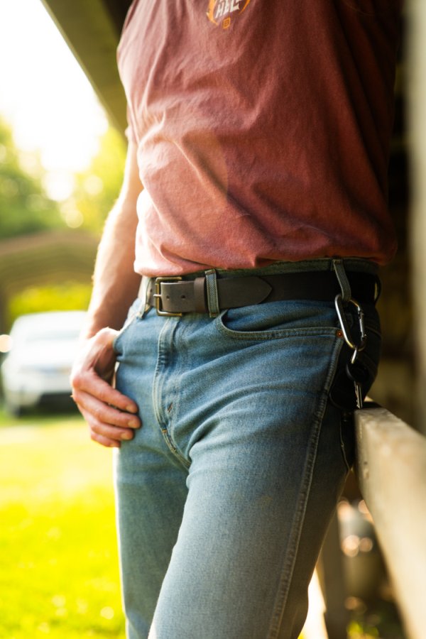 Men’s everyday brown leather belt worn with jeans and boots, handmade by Noble Buffalo in St. Louis, Missouri