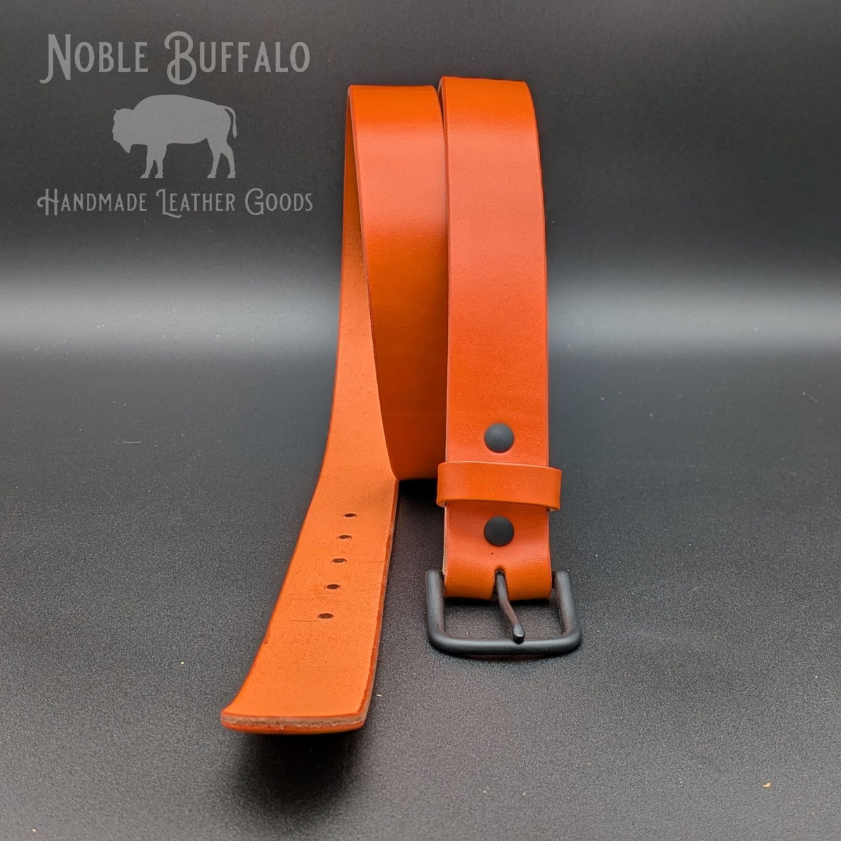 Carrot orange Wickett & Craig English Bridle leather belt shown with a matte black buckle