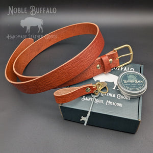 Full chestnut textured leather belt with brass buckle, matching keychain, leather balm, and Noble Buffalo gift box