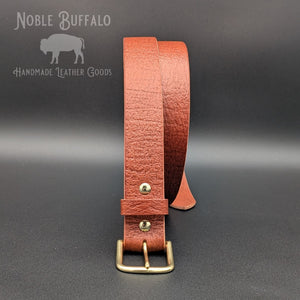 Front view of chestnut embossed Hermann Oak English Bridle belt with brass buckle and matching brass hardware