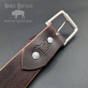 Close-up of the dark brown Illini Latigo belt’s buckle attachment, showing the Noble Buffalo stamp and Chicago screws.