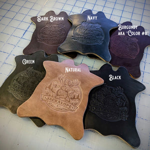 Jackalope embossed leather coasters shown in six Chromexcel colors: dark brown, navy, burgundy (color #8), green, natural, and black, displayed in cowhide shape.