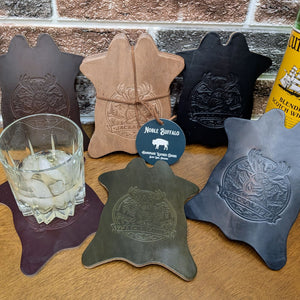 Handmade full grain leather drink coasters with embossed jackalope design, American made leather goods in multiple colors, built for everyday durability
